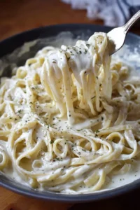 Creamy homemade Alfredo sauce served over fettuccine pasta