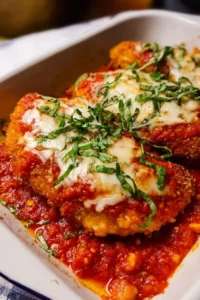 Delicious Chicken Parmesan served with marinara sauce and melted cheese