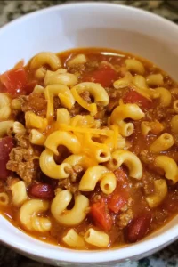 Delicious bowl of easy chili mac served with cheese and herbs