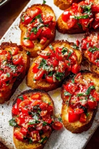 Delicious easy garlic bread bruschetta served on a plate with fresh toppings