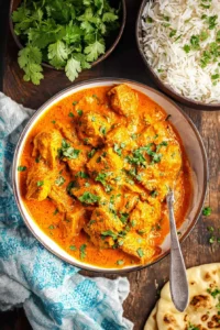 Healthy homemade butter chicken served with rice and garnished with cilantro.