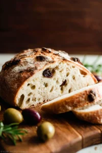 Freshly baked easy no-knead olive bread with herbs and olives
