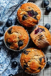 Freshly baked healthy blueberry banana muffins on a wooden table