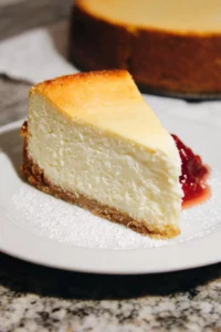 Delicious slice of New York cheesecake with a creamy texture and graham cracker crust