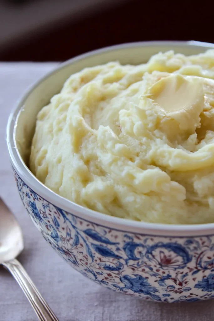 Perfect Creamy Mashed Potatoes 1 Bowl of perfect creamy mashed potatoes with butter and herbs