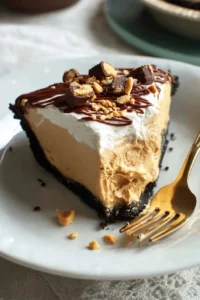 Delicious slice of unbelievable peanut butter pie topped with whipped cream.