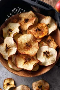 Crispy air fryer apple chips on a white plate
