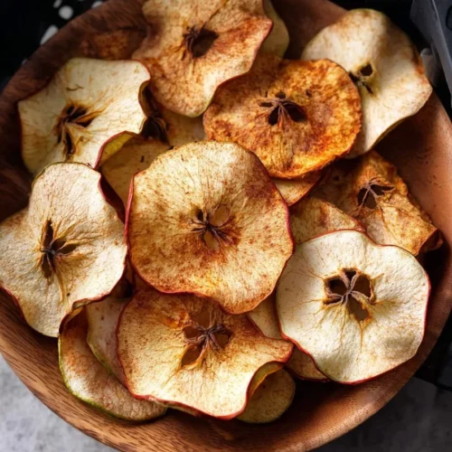 Crispy air fryer apple chips on a white plate
