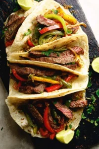 Delicious plate of amazing steak fajitas with vibrant peppers and onions