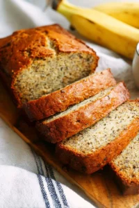 Loaf of award winning banana bread on a wooden cutting board