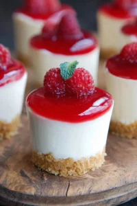 Delicious cheesecake dessert cups garnished with fresh fruit and whipped cream.