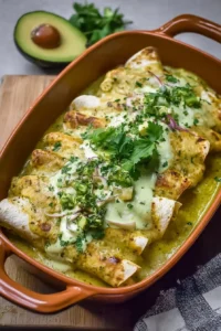 Delicious chicken enchiladas served with creamy avocado sauce on top