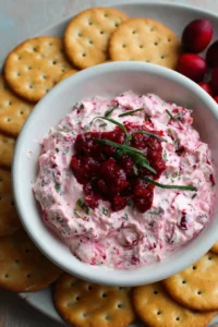 Creamy Cranberry Jalapeño Dip served in a bowl with chips on the side