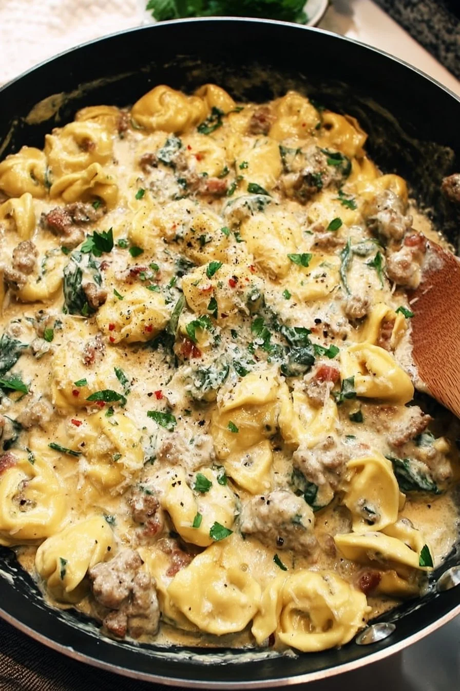Creamy sausage tortellini skillet served in a pan with garnish