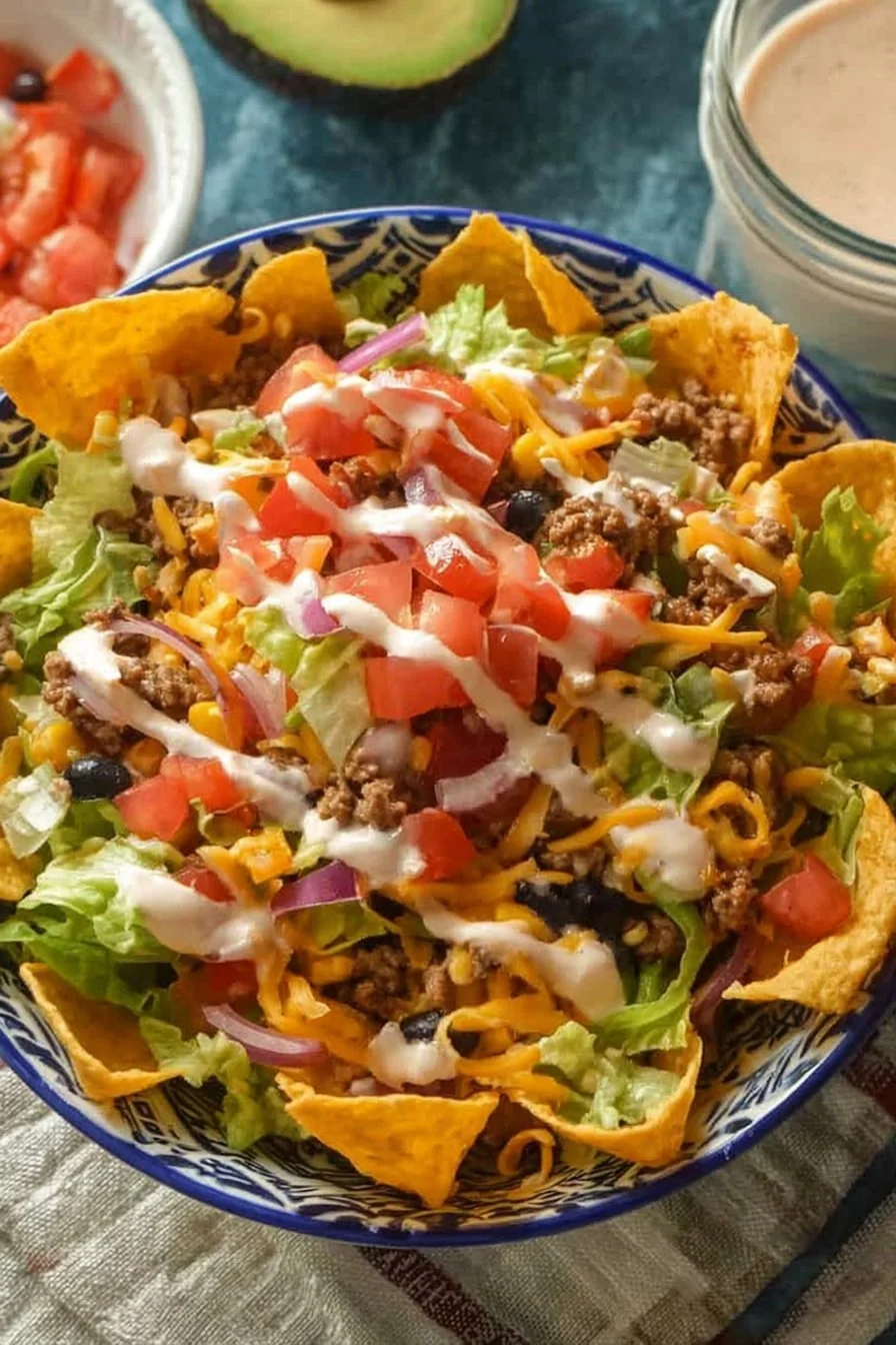 Delicious creamy taco salad with layers of fresh ingredients and toppings