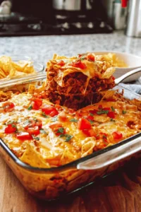 Delicious homemade Dorito Casserole topped with melted cheese and crunchy Doritos
