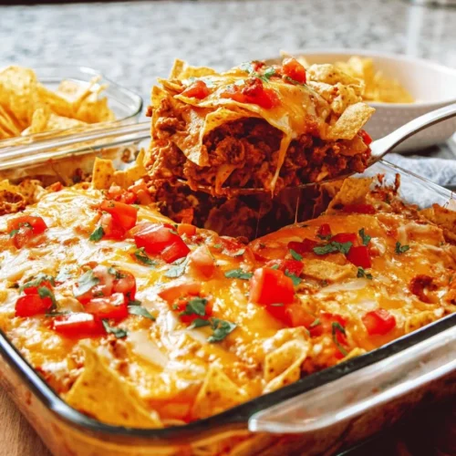Delicious homemade Dorito Casserole topped with melted cheese and crunchy Doritos
