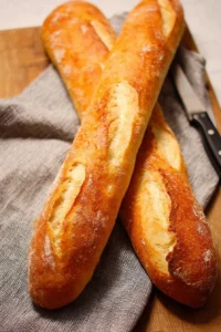 Freshly baked French Baguette on a wooden table