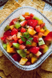 Bowl of fresh fruit salsa with colorful fruits and herbs