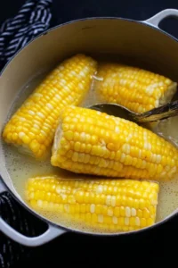 Boiling corn on the cob in a pot of water for a delicious summer treat.