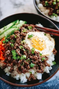 Korean Ground Beef Rice Bowl garnished with vegetables and sesame seeds