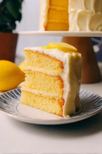 Delicious Lemon Layer Cake with layers of lemon frosting on a white plate