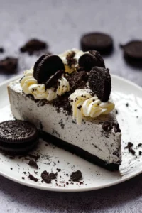 No-Bake Oreo Cheesecake topped with crushed Oreos on a dessert plate