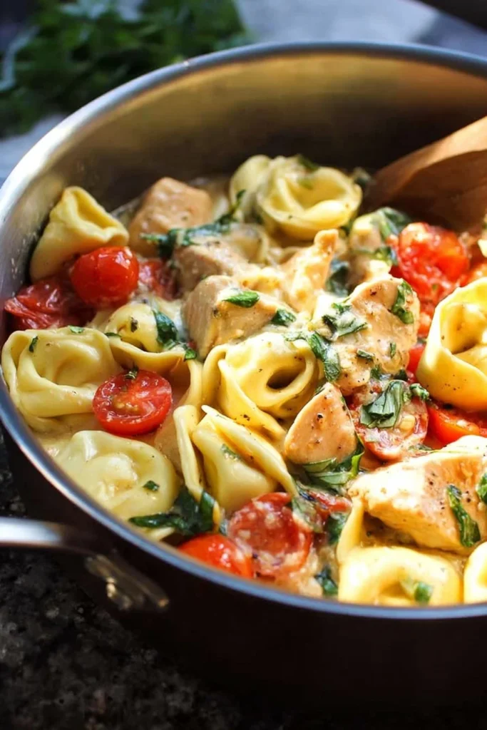 Creamy Parmesan Chicken Tortellini in a bowl, garnished with parsley