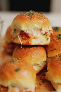 Plate of tasty pizza sliders topped with melted cheese and pepperoni