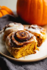Delicious Pumpkin Cinnamon Rolls topped with cream cheese icing