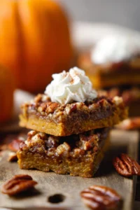 Delicious Pumpkin Pecan Pie Bars served on a platter with autumn decorations