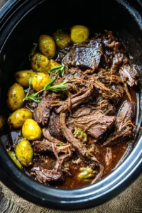 Delicious Mississippi pot roast served with rich gravy and herbs.