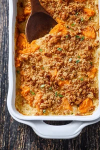 Savory sweet potato casserole topped with crunchy pecans and marshmallows
