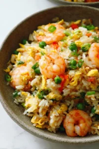 Delicious shrimp fried rice with colorful vegetables in a bowl