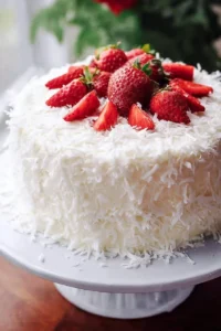Strawberry Coconut Cream Cake with Coconut Cream Cheese Frosting on a plate