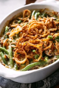 Delicious green bean casserole topped with crispy onions and creamy sauce.