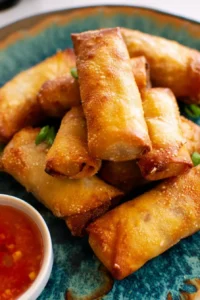 Delicious air fryer egg rolls served with dipping sauce on a plate