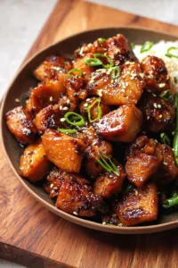 Serving of Air Fryer Teriyaki Chicken garnished with sesame seeds and green onions.