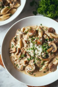 Delicious creamy mushroom stroganoff served in a bowl with herbs.
