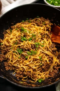 Plate of Mongolian ground beef served with noodles and vegetables