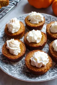 Delicious pumpkin pie cupcakes with creamy whipped cream topping