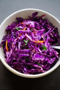 Fresh and colorful Red Cabbage Slaw served in a bowl.