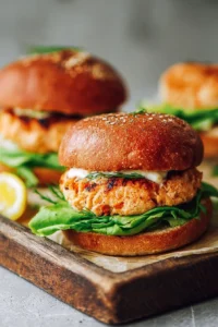 Juicy salmon burger served with fresh toppings and side dishes.