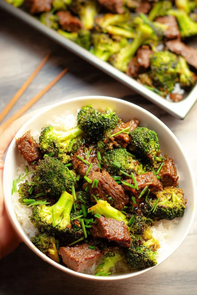 Sheet pan meal featuring tender beef and fresh broccoli cooked together.
