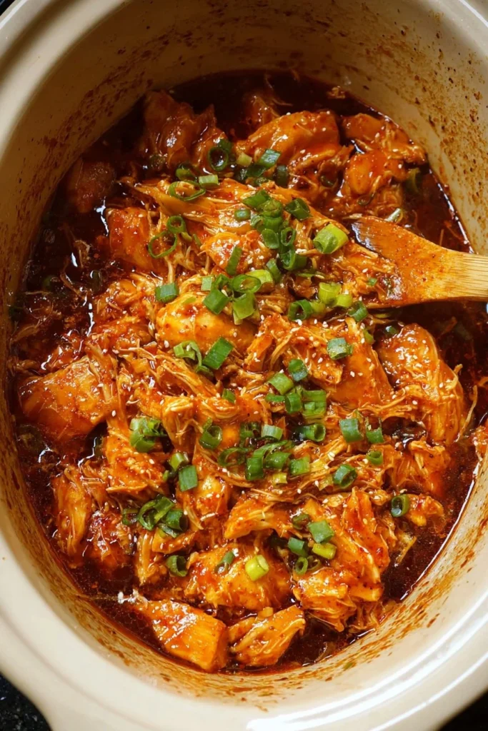 Delicious Slow Cooker Honey Sriracha Chicken served with rice and vegetables.