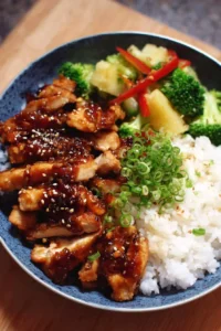 Plate of Sweet Island Teriyaki Chicken garnished with sesame seeds and green onions.