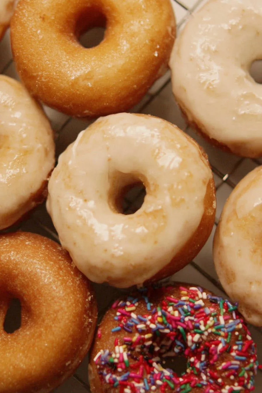 Delicious homemade cake donuts with colorful icing and sprinkles