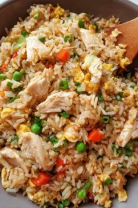 Delicious chicken fried rice with vegetables and chicken pieces served on a plate