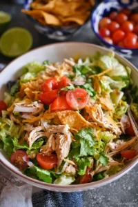 Colorful Taco Chicken Salad with grilled chicken, veggies, and taco seasoning