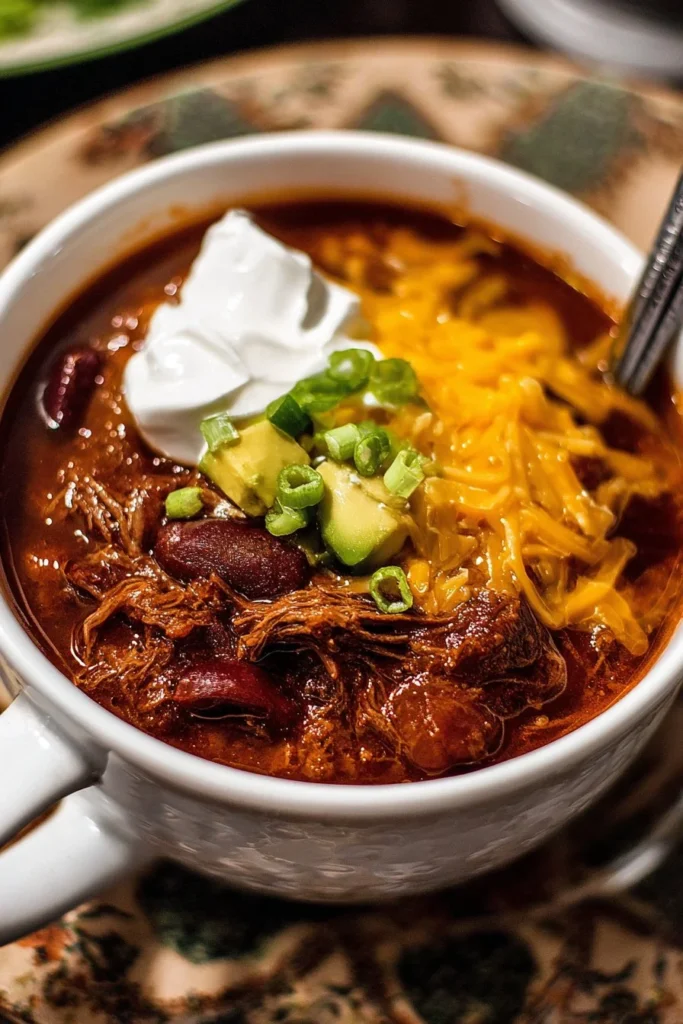 Delicious bowl of Crock-Pot chili topped with cheese and herbs